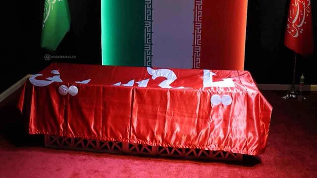 Khamenei's coffin draped in the red flag of Imam Reza's shrine